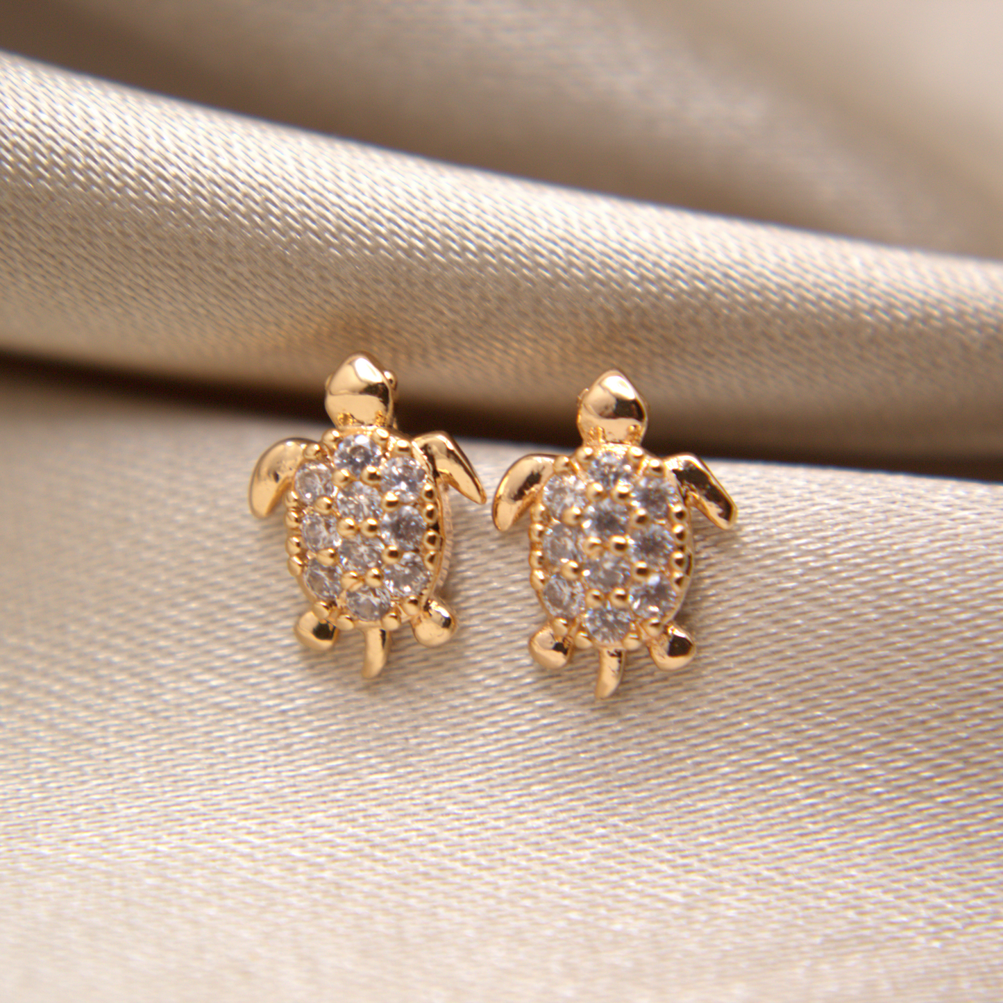 Ocean-inspired gold turtle earrings, hypoallergenic and waterproof.